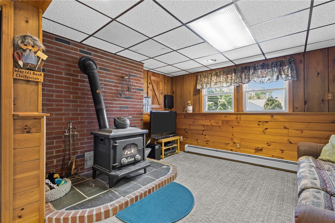 11 Bourassa Avenue Woonsocket, RI 02895 - Photo 28 of 39 Lower level family room/rec room with wood stove