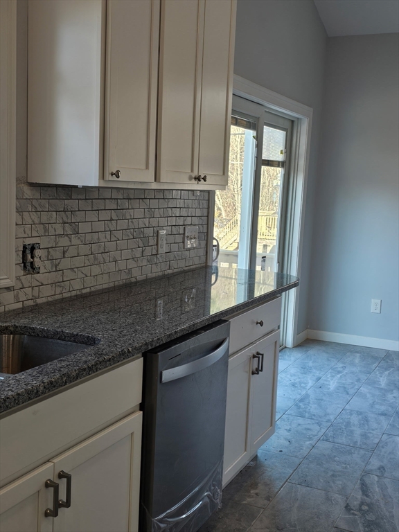 88 Stafford Holland Road Wales, MA 01081 - Photo 5 of 31 a kitchen with granite countertop a sink stainless steel appliances white cabinets and a window