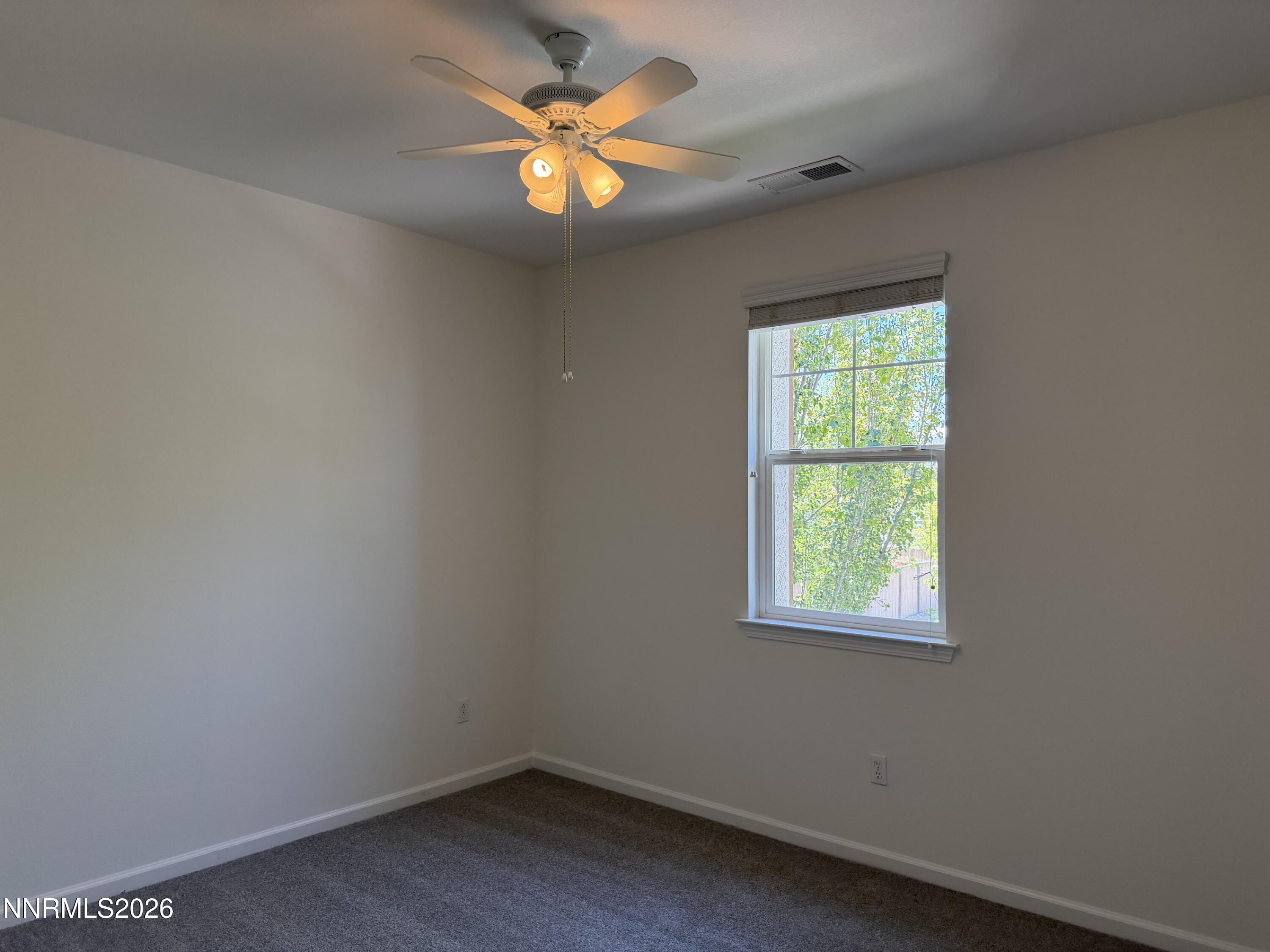 10890 Oakhaven Drive Reno, NV 89521 - Photo 20 of 28 an empty room with a window and a fan