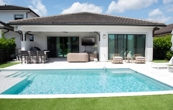 a view of a house with swimming pool and porch