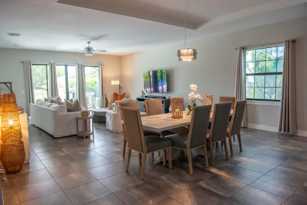 a view of a dining room with furniture and a chandelier