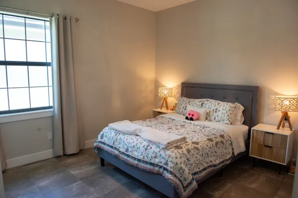 a bedroom with a bed and window