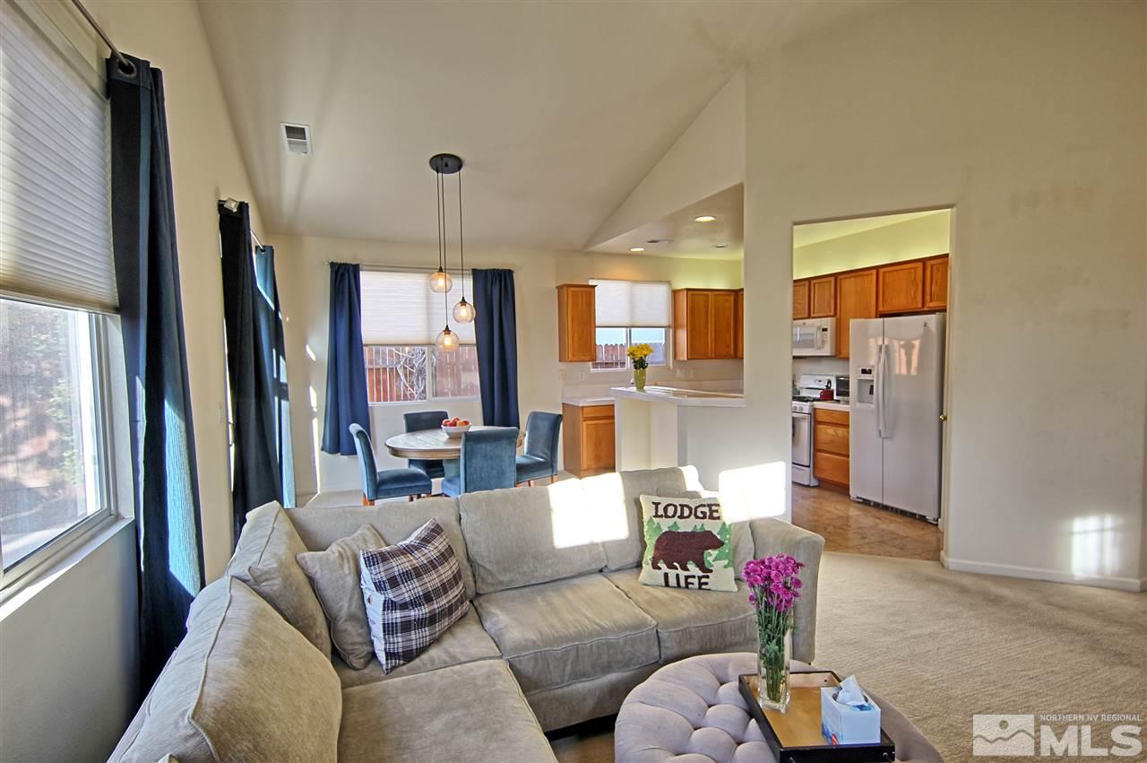 10467 Summershade Lane Reno, NV 89521 - Photo 6 of 23 a living room with furniture potted plant kitchen view and a large window