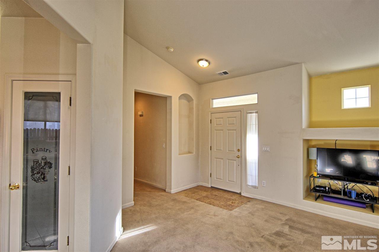 10467 Summershade Lane Reno, NV 89521 - Photo 10 of 23 a view of a livingroom with a flat screen tv and floor to ceiling window