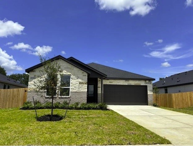 415 Robin Court Angleton, TX 77515 - Photo 1 of 9 a front view of a house with a yard and a garage