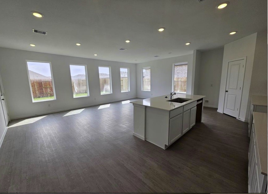 415 Robin Court Angleton, TX 77515 - Photo 5 of 9 a view of an empty room with window and wooden floor