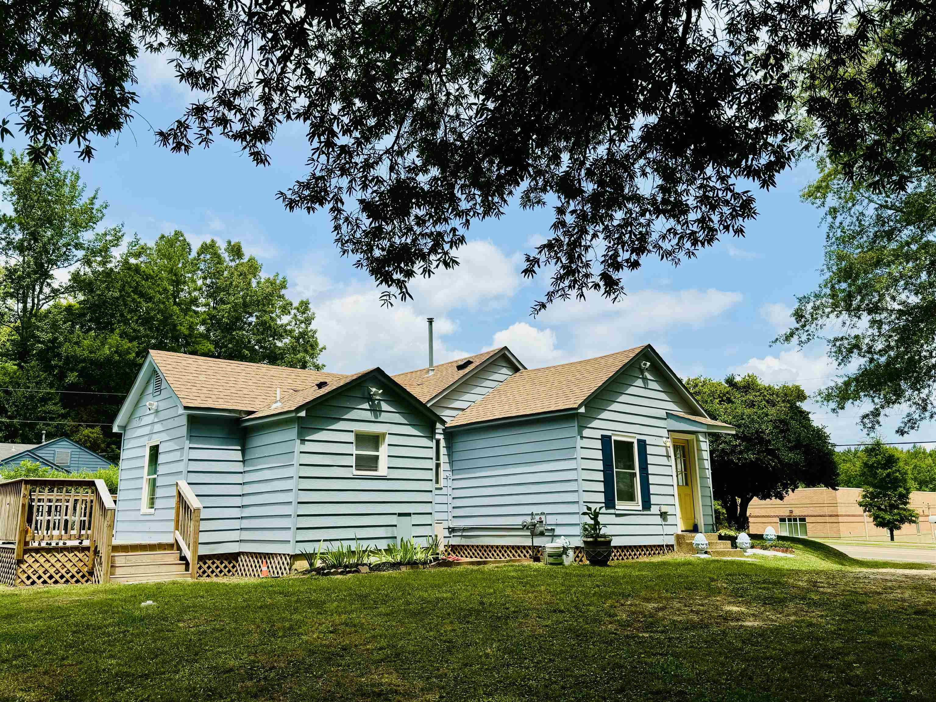 Exterior space featuring a front yard and a deck