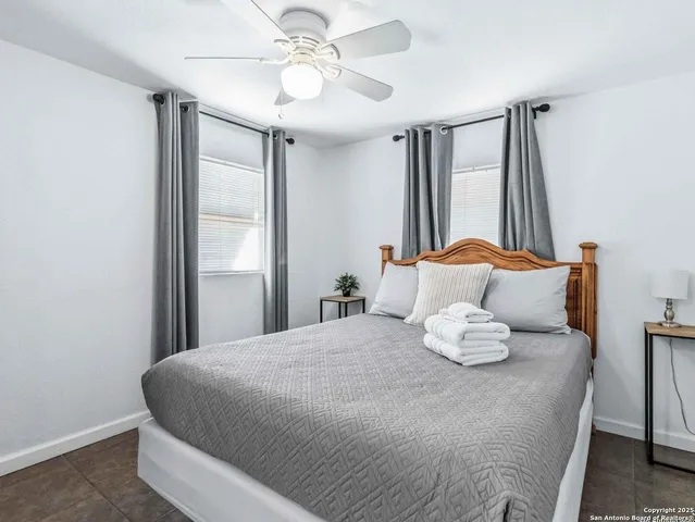 a bedroom with furniture and wooden floor