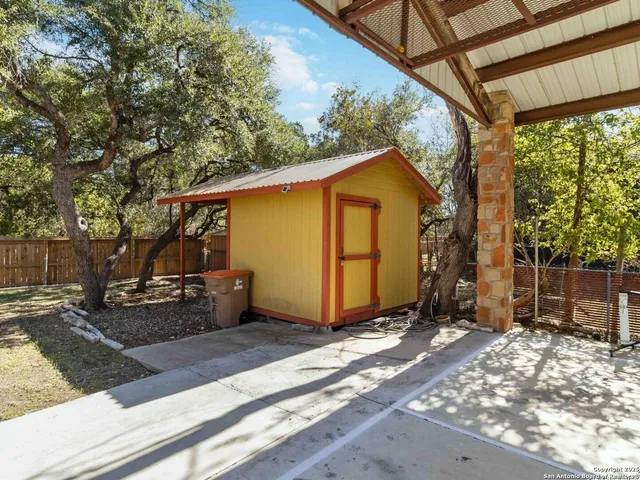 a view of a backyard with a tree
