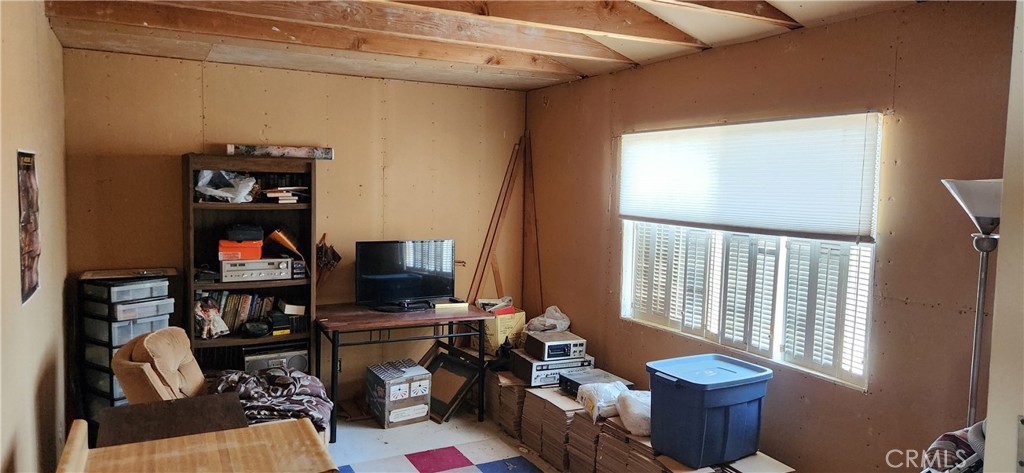60812 Adele Road Landers, CA 92285 - Photo 13 of 19 a living room with furniture a rug and a window