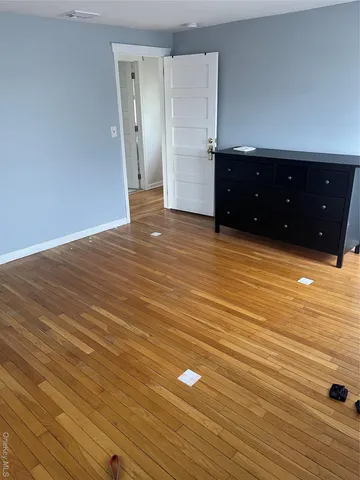 a view of a room with wooden floor