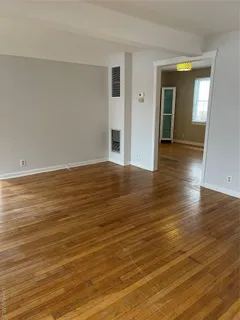 a view of a room with wooden floor