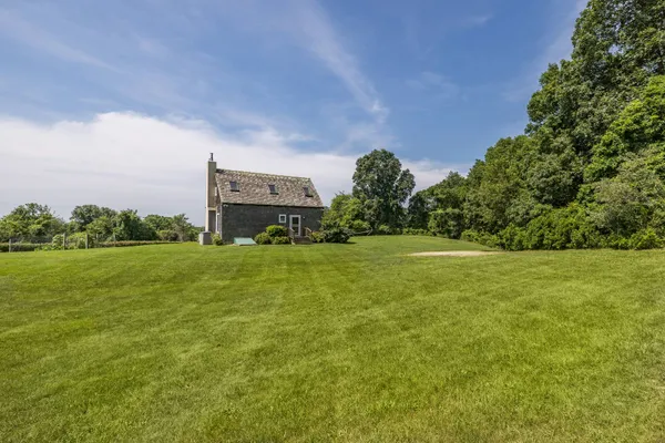 a view of a big yard with a house in the background