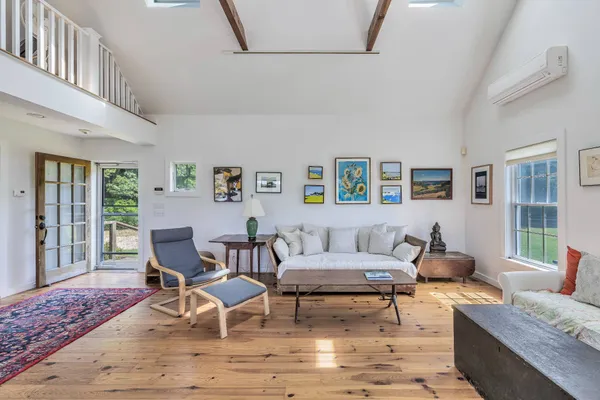 a balcony with wooden floor table and chairs