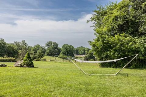 a view of a field of grass and trees