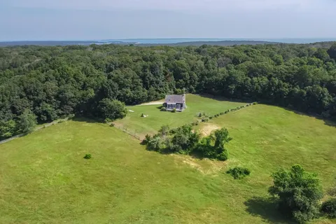 a backyard of a house with a yard and outdoor seating