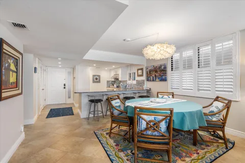 a view of a dining room with furniture and chandelier