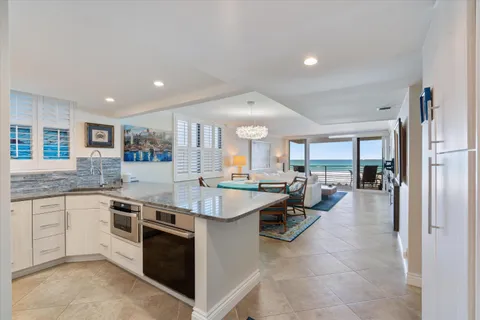 a large kitchen with a large counter top furniture and appliances