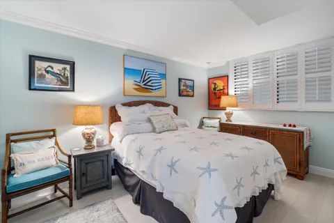 a bedroom with bed and wall painting with wooden floor