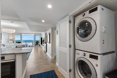 a view of a kitchen with a washer and dryer