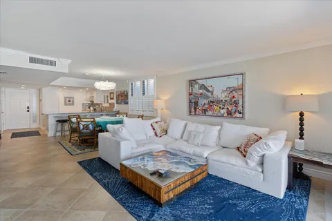 a living room with furniture a rug and a painting