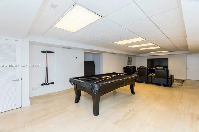 a living room with furniture a rug and white walls