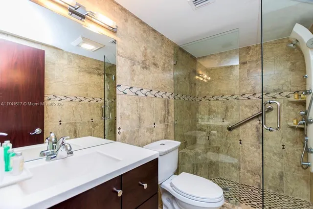 a bathroom with a sink a toilet and mirror