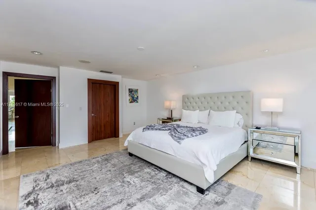 a spacious bedroom with a bed and window