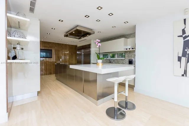 a large kitchen with a table and chairs