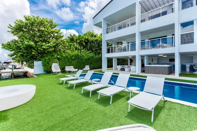 a view of a swimming pool and outside seating area