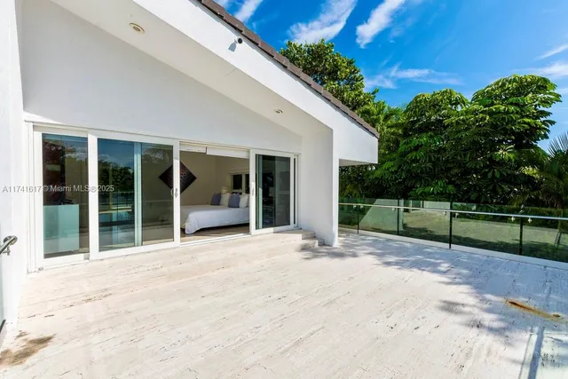 a room with a bed and a view of living room
