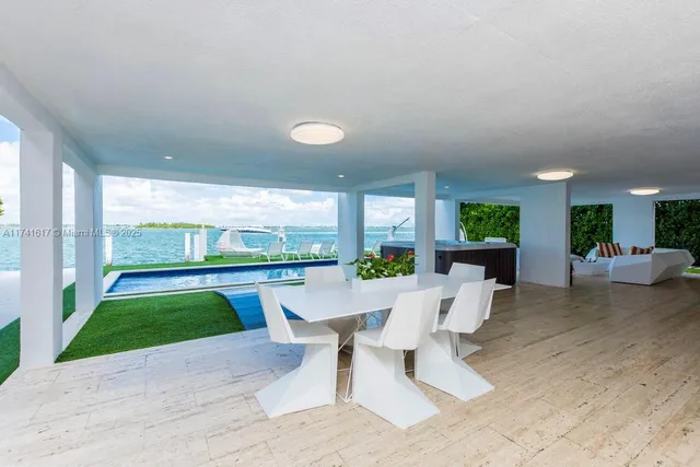 a living room with large couches a flat screen tv and a large window