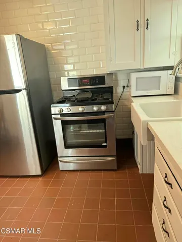a view of a kitchen with appliances and cabinets