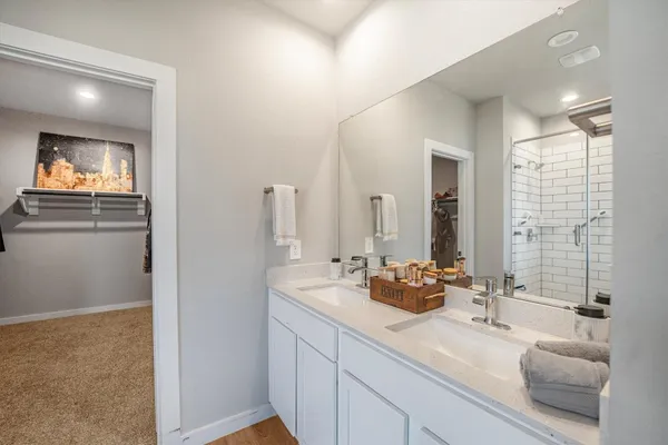 a bathroom with a double vanity sink and mirror