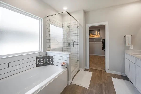 a bathroom with a bathtub and a sink