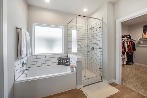 a bathroom with a bathtub and a shower