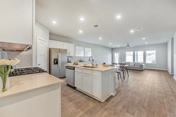a kitchen with a sink appliances and cabinets