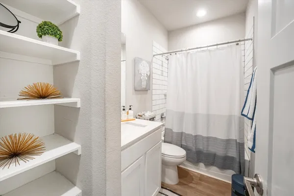 a bathroom with a toilet a sink and a shower