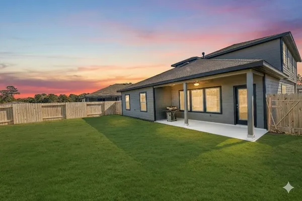 a view of a house with a backyard