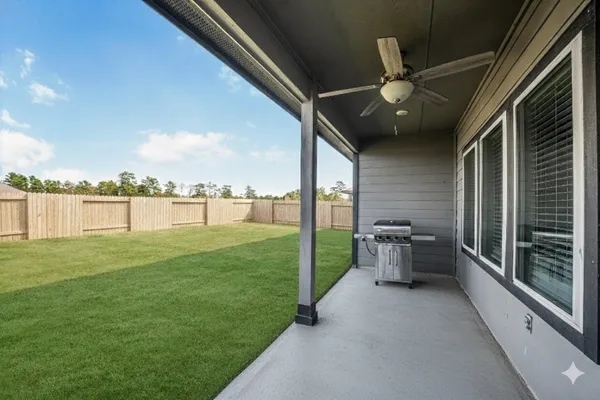 a view of a swimming pool with a yard and furniture
