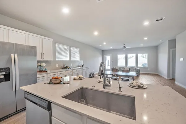 a kitchen with a sink a counter and chairs