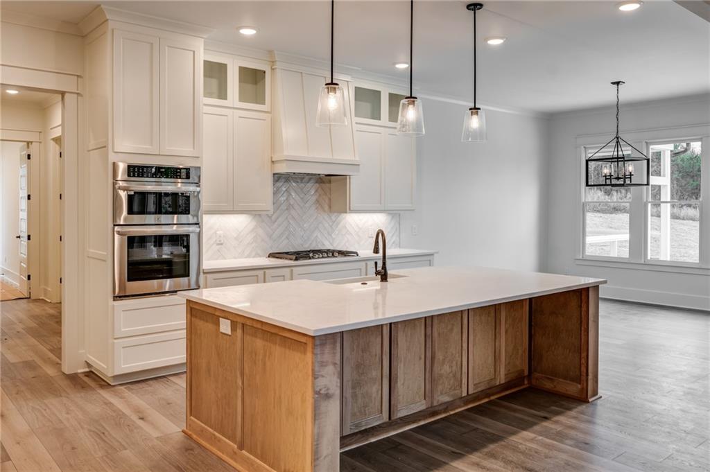1 Cason Drive Canton, GA 30114 - Photo 11 of 28 a kitchen with a stove a sink a window and chairs