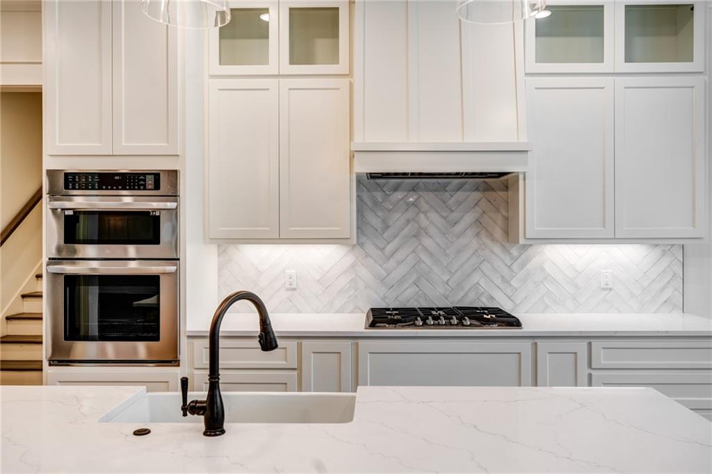 1 Cason Drive Canton, GA 30114 - Photo 12 of 28 a kitchen with granite countertop a stove and a sink
