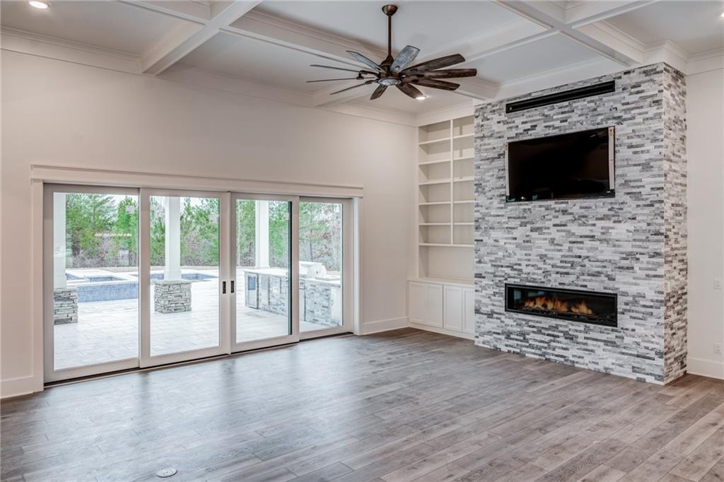 1 Cason Drive Canton, GA 30114 - Photo 8 of 28 a living room with a fireplace and a flat screen tv