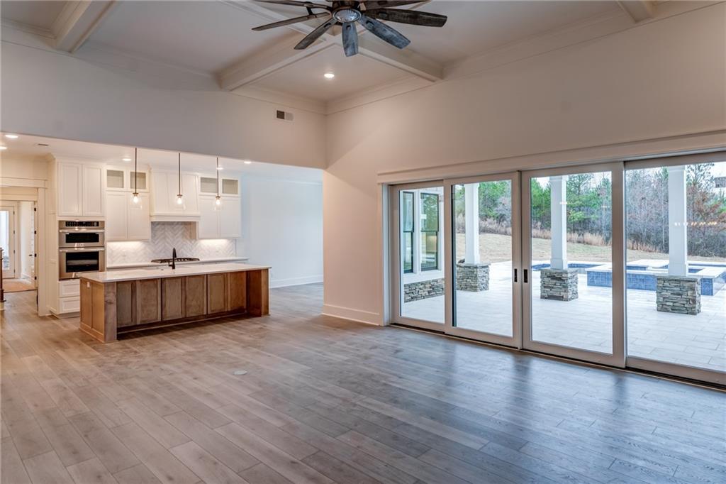 1 Cason Drive Canton, GA 30114 - Photo 9 of 28 a large white kitchen with a large window a sink and stainless steel appliances