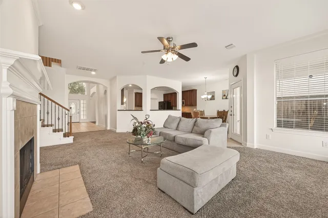 a living room with furniture ceiling fan and a rug