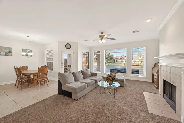 a living room with furniture fireplace and window