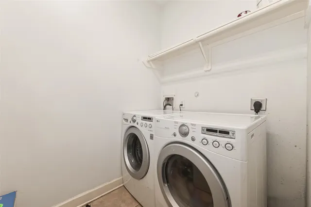 a porch with a table and chairs next to a yard