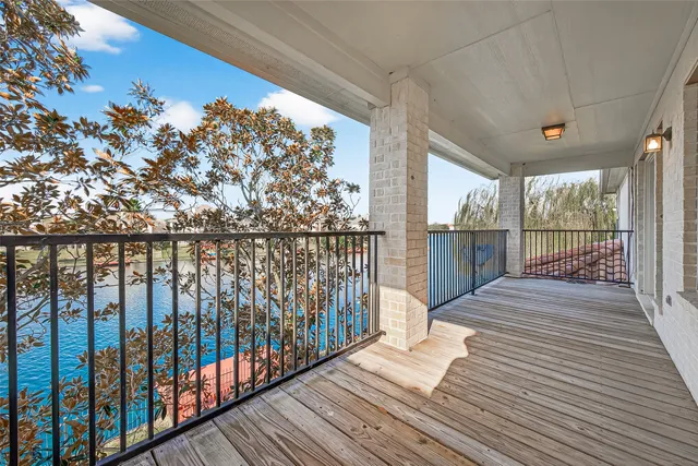 a view of a house with a big yard and large trees