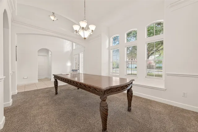 a room with pool table and windows